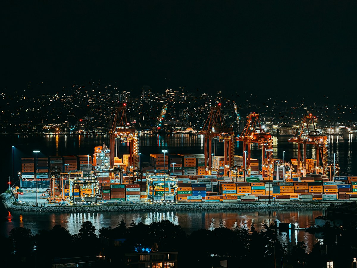 Shipping containers and cranes at a busy Vancouver port